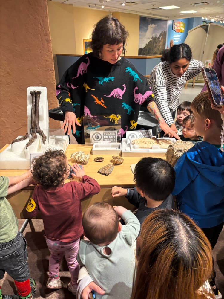 Photo of Jingmai O'Connor doing outreach work in front of a group of children